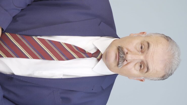 Vertical video of Old businessman with visual impairment.