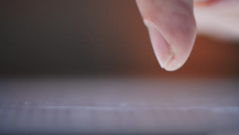 macro-closeup-finger-touching-tablet-computer-touchscreen