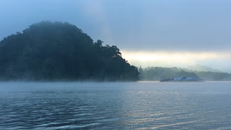 foggy river with mountain and distant structures