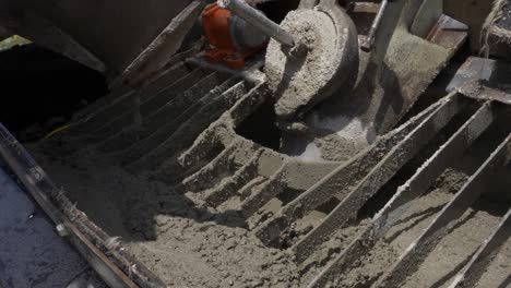 view inside a concrete mixer being filled with wet concrete and cement