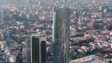 mitikah tower with drone parallax effect, featuring megacity of mexico city in background