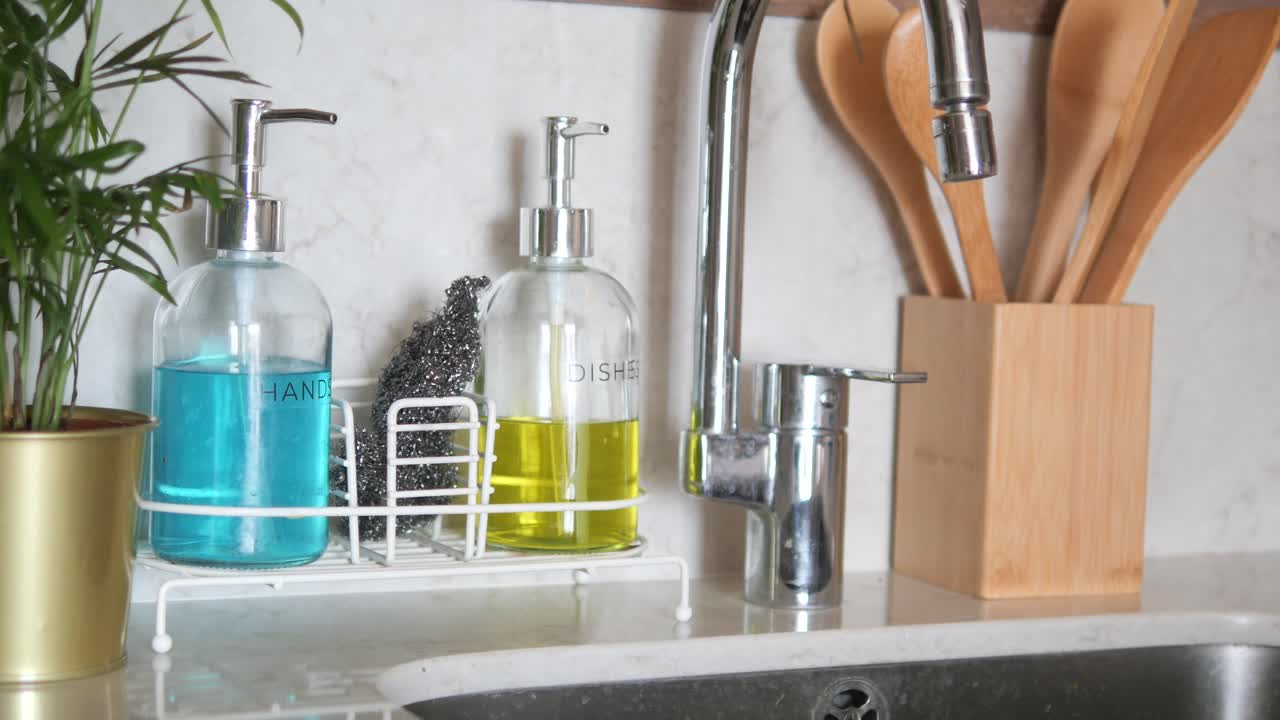 Kitchen Sink with Soap Dispensers and Wooden Spoons