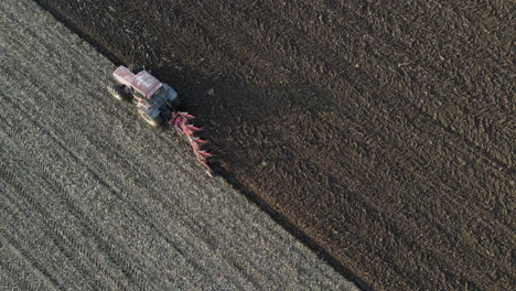 birds eye view of tractor ploughing dry fields ready for planting, overhead aerial view