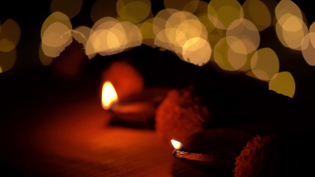 Person Illuminated Diwali Diya Lamps At Temple