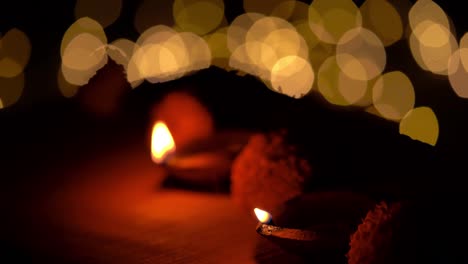 person illuminated diwali diya lamps at temple