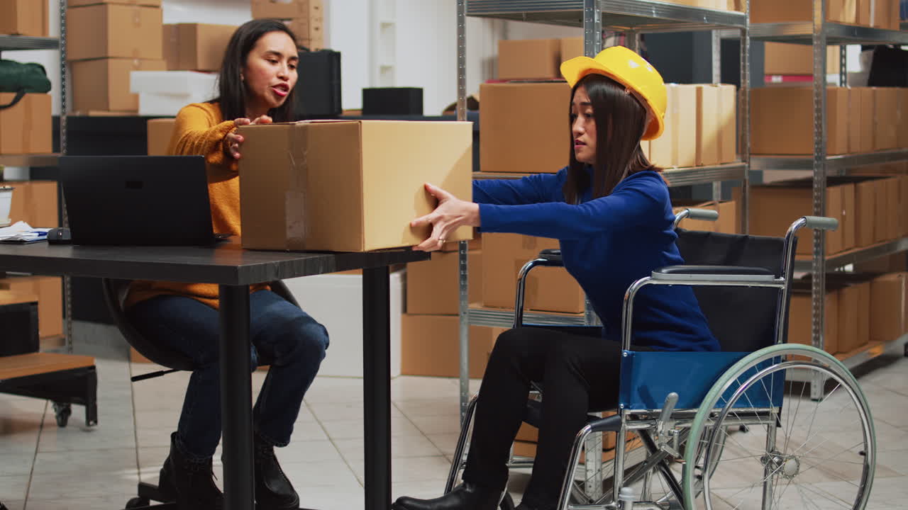 Warehouse worker in wheelchair with packages