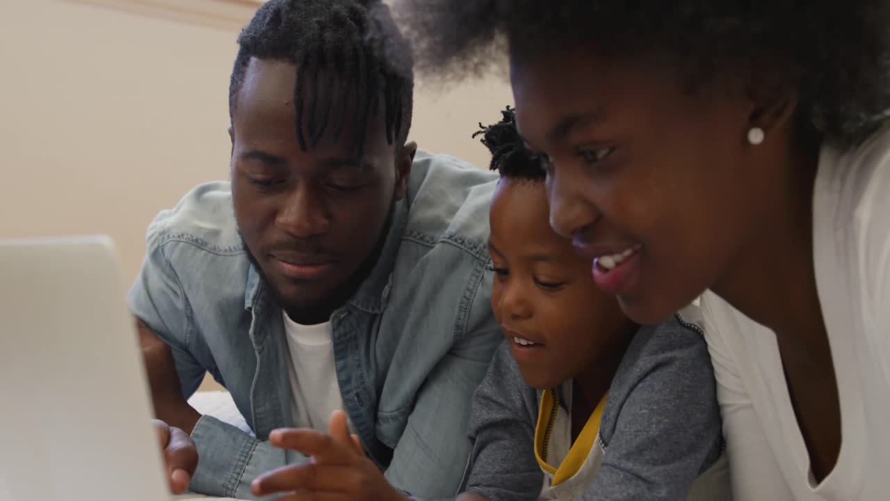 Family using laptop together at home