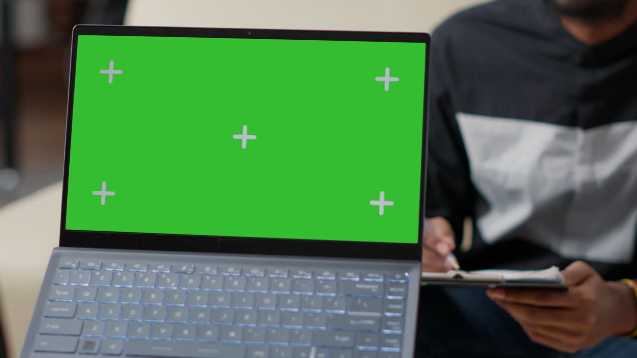 Office worker holding laptop with green screen background