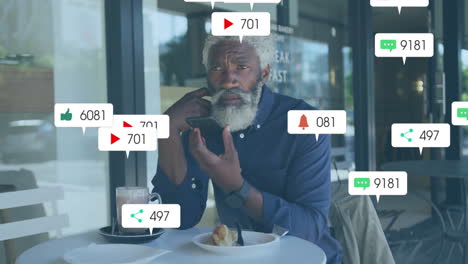 Animación-De-Notificaciones-De-Redes-Sociales-Sobre-Un-Hombre-Afroamericano-Mayor-Usando-Un-Teléfono-Inteligente
