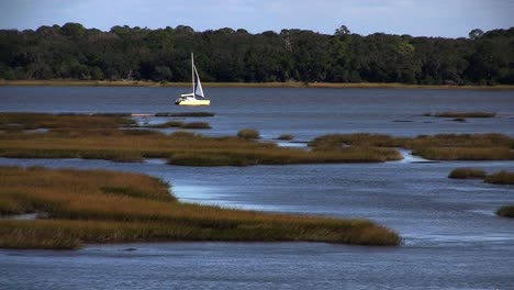 A-distant-sailboat-on-a-river