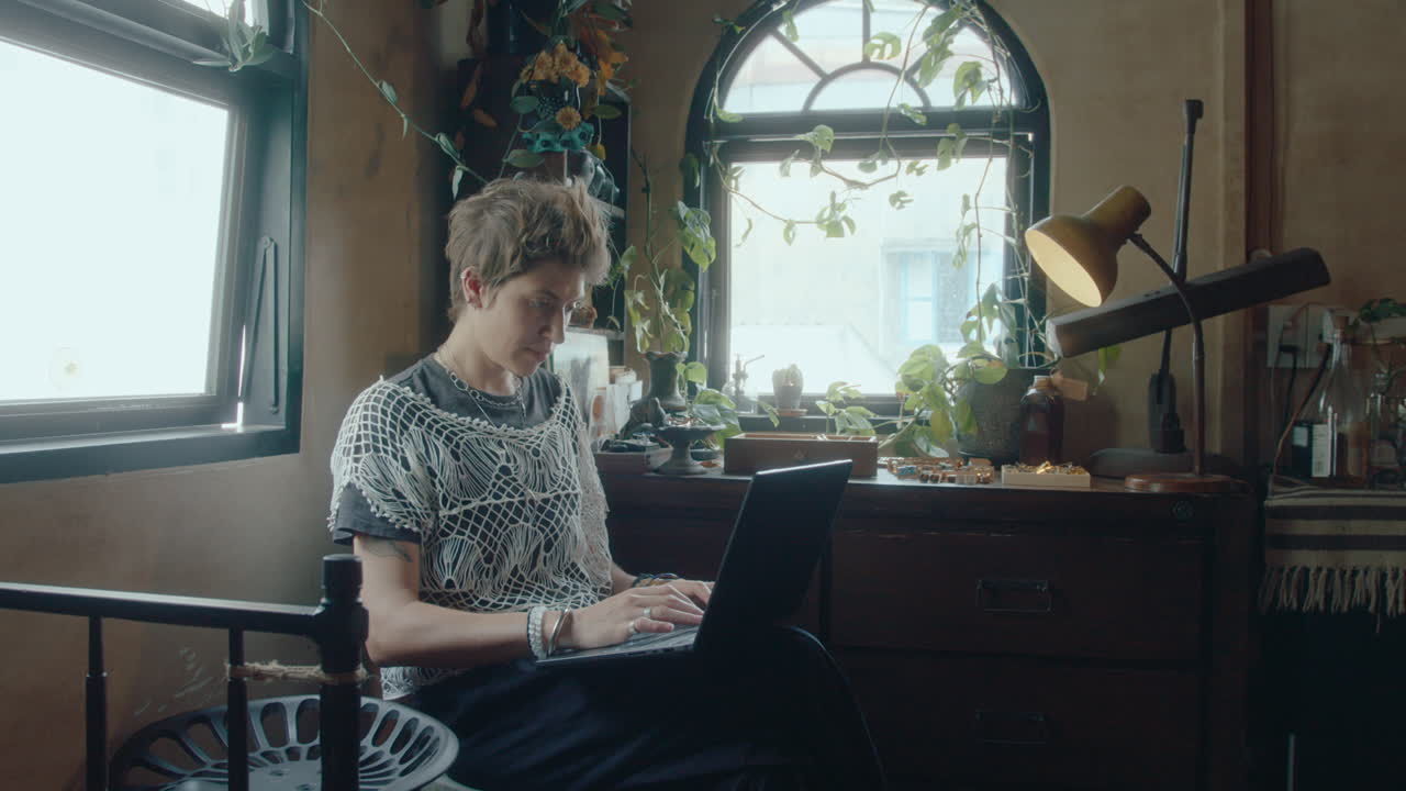 Young Woman Working on Laptop in Antiques Store