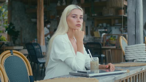 woman working at an outdoor cafe