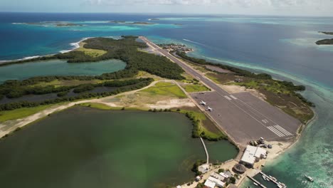 gran roque pista de aterrizaje, isla tropical, mar, y se acerca avión en movimiento, vista aérea