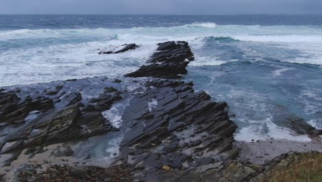 Slow-motion-aerial-shot-flying-towards-crashing-waves