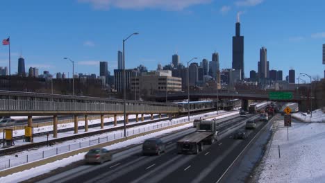 cars travel on a freeway into chicago in winter