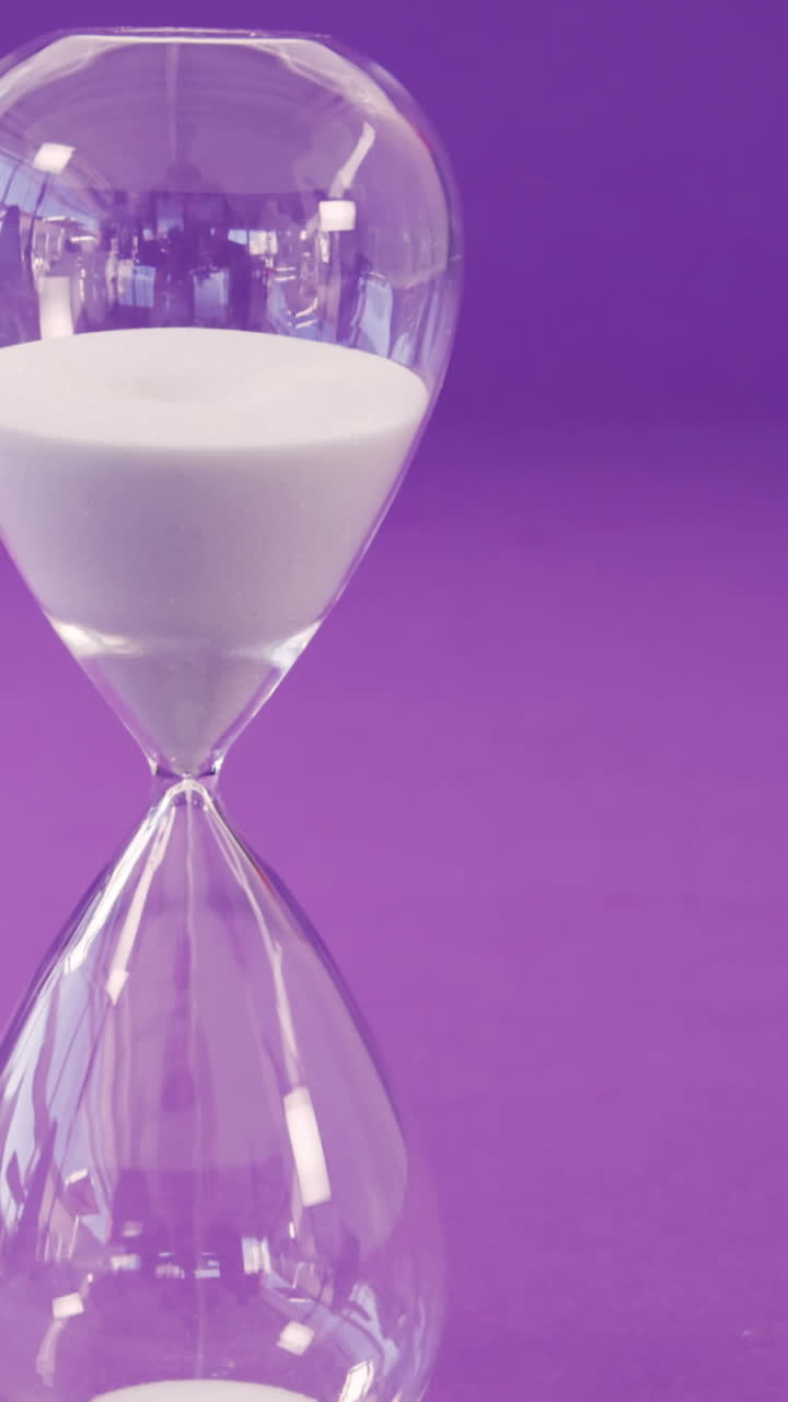 Sandglass against purple background
