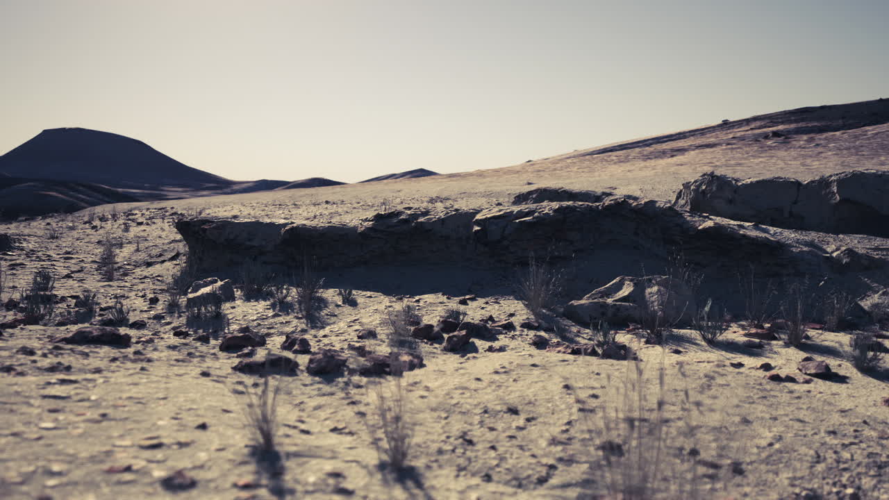 Barren landscape of mongolia showcasing rocky terrain and distant hills