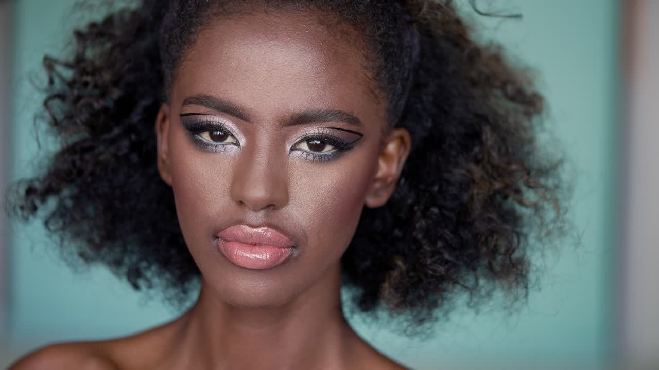 Portrait of a Woman with Bold Makeup and Curly Hair