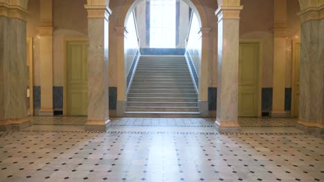 huge marble villa hall with columns and sunny staircase