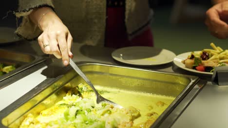 restaurant guests select food from a buffet