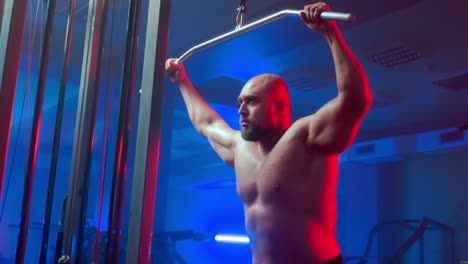 man performing lat pulldowns in gym