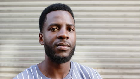 Young-African-American-man-with-a-beard,-wearing-a-striped-shirt