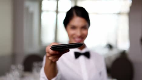Pretty-waitress-passing-the-bill