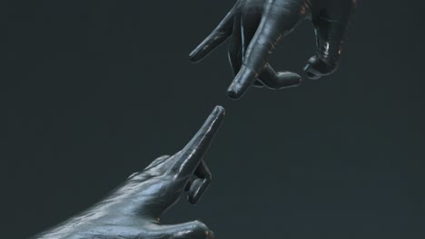 Dark-stone-hands-touching-creativity