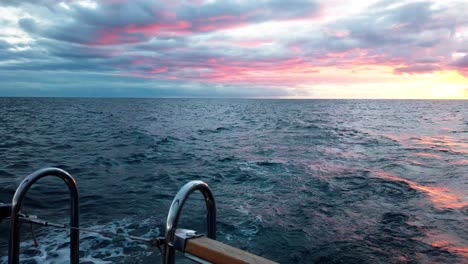 magnificent sunset sky viewed from a cruising yacht in madeira island, portugal, wide shot, pov