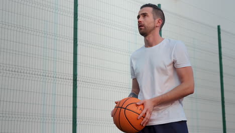 man playing basketball outdoors