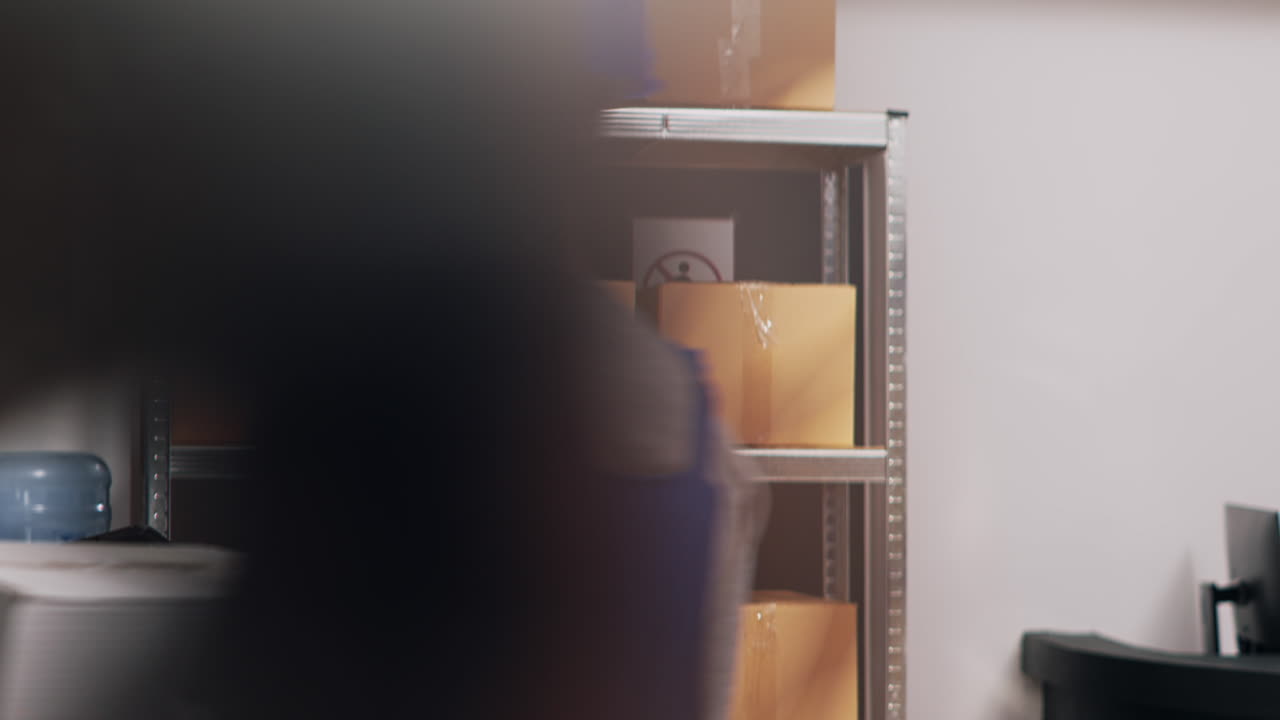 Warehouse workers discussing inventory in storage room