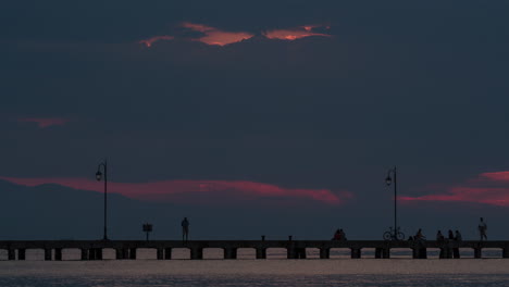 Timelapse of people on pier in the evening