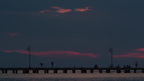 timelapse of people on pier in the evening