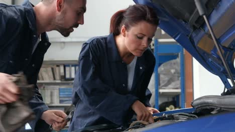 mechanics repairing an engine