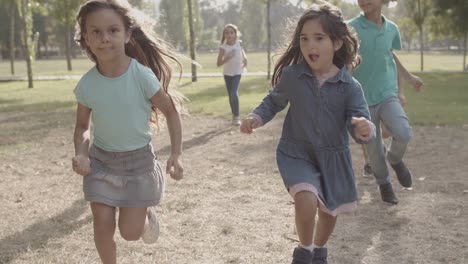 cropped view of happy children running together in the park