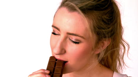 pretty blonde eating a chocolate bar