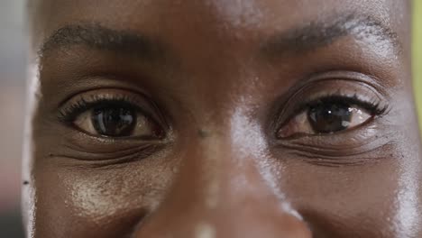 Portrait-close-up-of-eyes-of-happy-african-american-businesswoman-smiling,-in-slow-motion