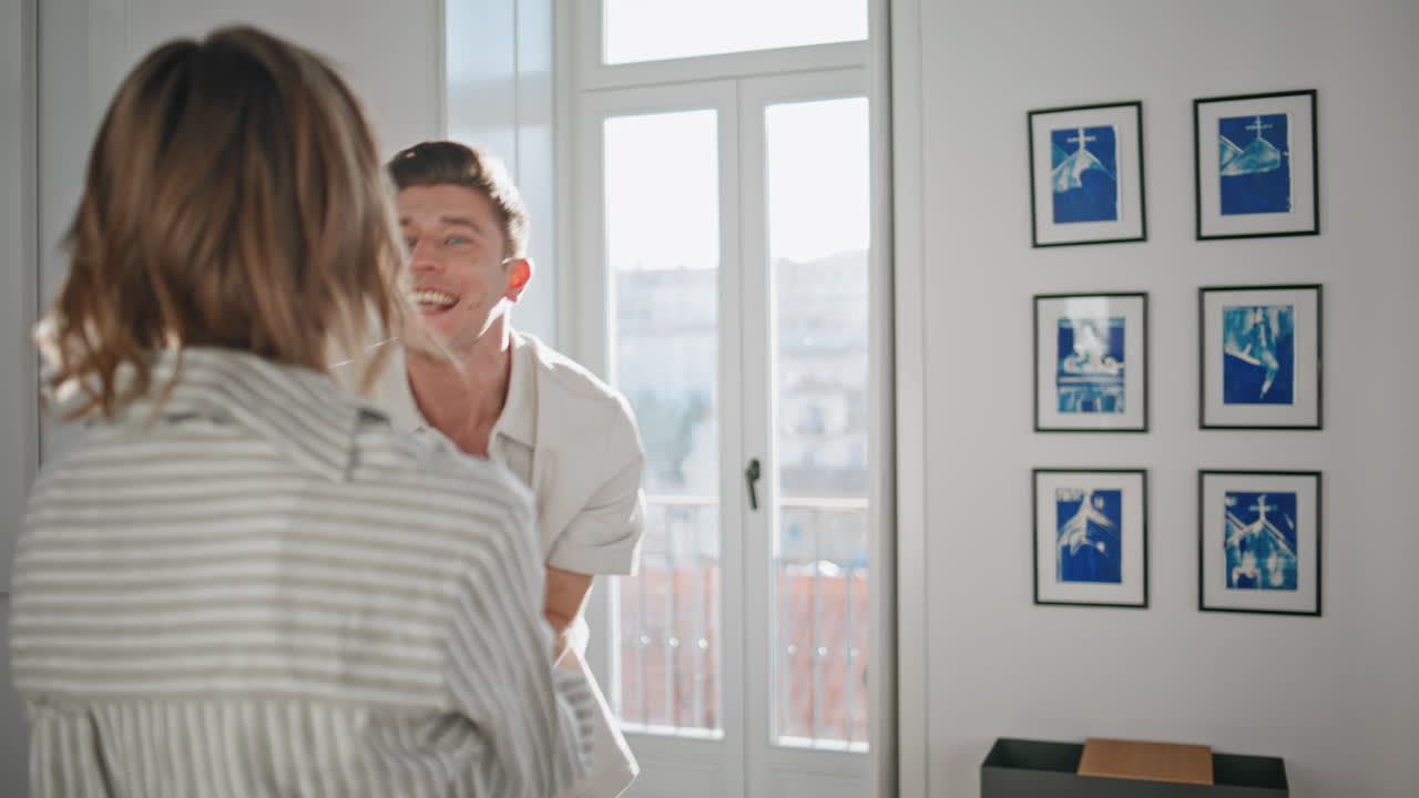 Excited newlyweds embracing home closeup. Happy man celebrating buying apartment