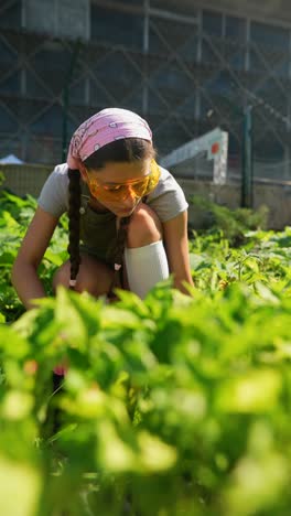 teenage girl gardening in urban community garden