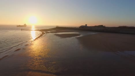 Aerial:-The-boulevard,-beach-and-city-of-Vlissingen-during-sunset