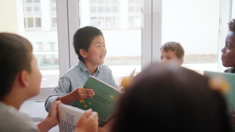 children reading a book together