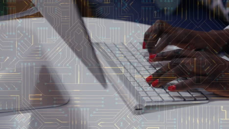 Animation of circuit board over african american woman using computer