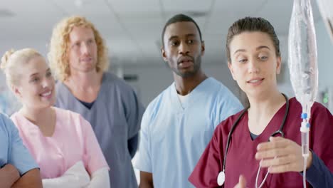 caucasian female doctor training diverse trainee doctors, applying drip, slow motion