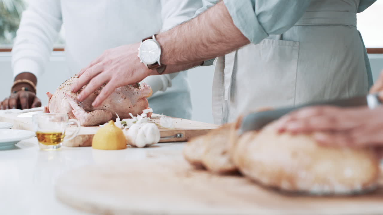 an unrecognisable man preparing a stuffed turkey