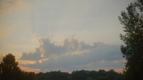 sunset over serene forest and clouds