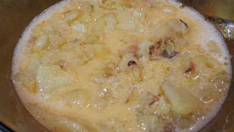 omelette ingredients being dropped on large bowl