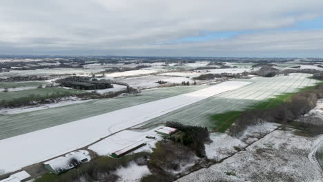 Aerial-drone-shot-of-a-snowy-landscape-under-an-overcast-sky