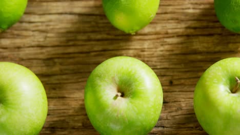 Green-apple-and-sliced-lemon-arranged-on-wooden-table-4K-4k