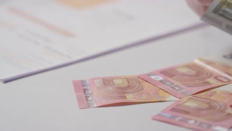 close up of hand counting currency in euros to pay for european energy bill 1