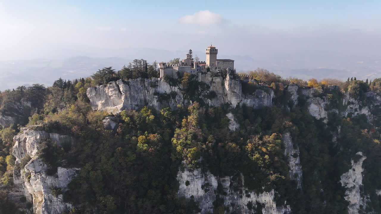 Aerial drone footage of the iconic Guaita Tower amidst the dramatic San Marino mountain range.